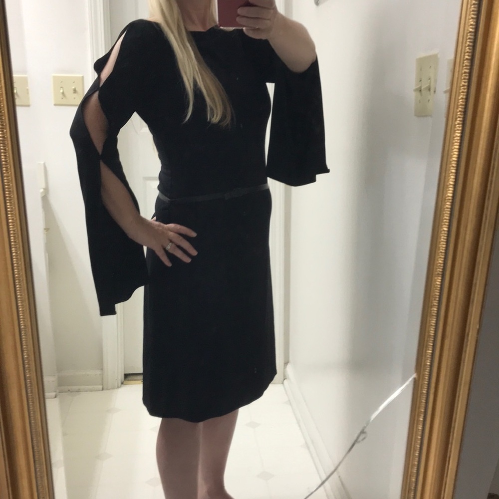 Black body-con dress with open sleeves.